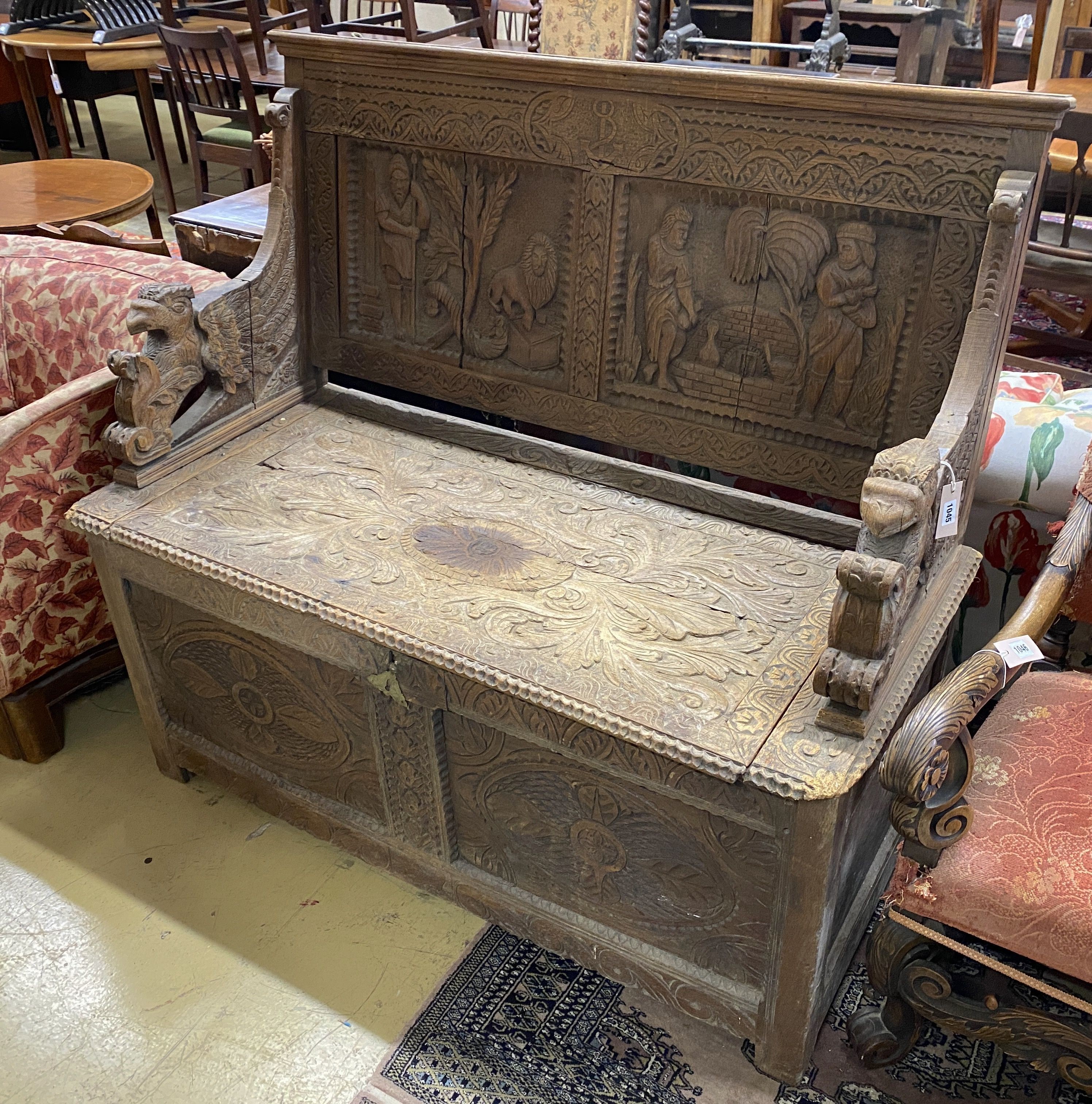 A late 19th century Flemish carved oak settle, length 130cm, depth 58cm, height 118cm